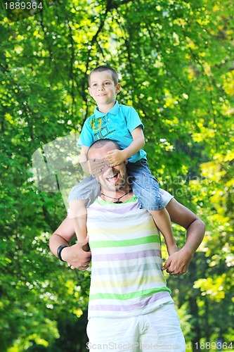 Image of happy father and son have fun at park