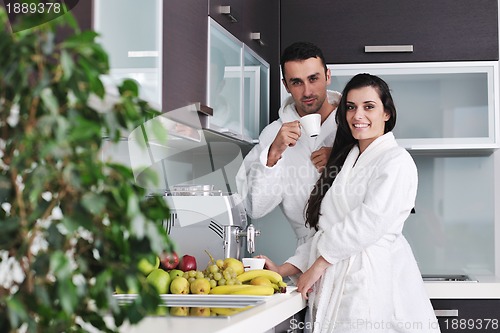 Image of Young love couple taking fresh morning cup of coffee