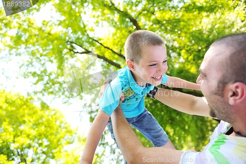 Image of happy father and son have fun at park