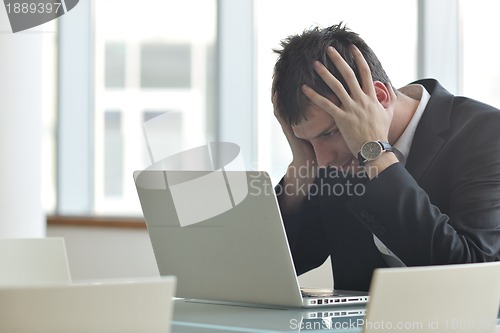 Image of young business man alone in conference room