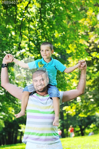 Image of happy father and son have fun at park