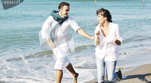 Image of happy young couple have fun at beautiful beach