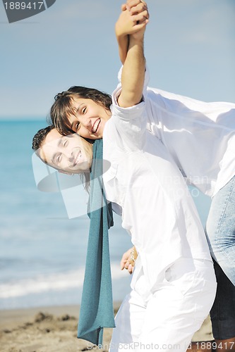 Image of happy young couple have fun at beautiful beach