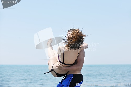 Image of happy young couple have fun on beach