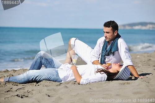 Image of young couple enjoying  picnic on the beach