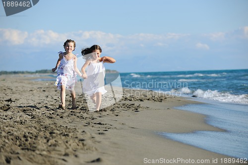Image of cute little girls running on beach