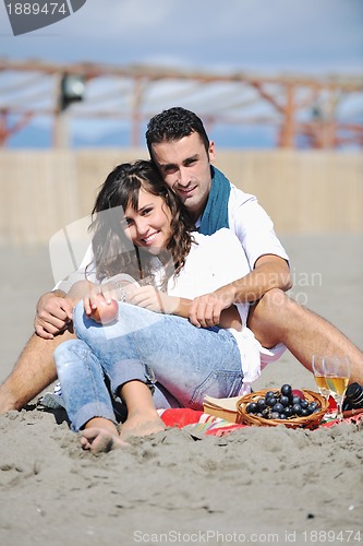 Image of young couple enjoying  picnic on the beach