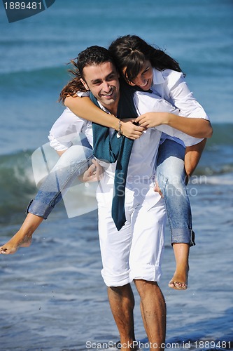 Image of happy young couple have fun at beautiful beach