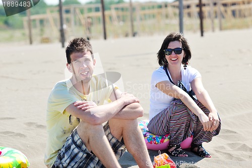 Image of happy young couple have fun on beach