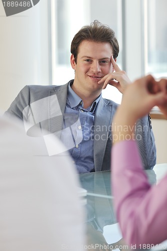 Image of young business man alone in conference room