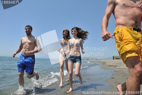 Image of happy people group have fun and running on beach