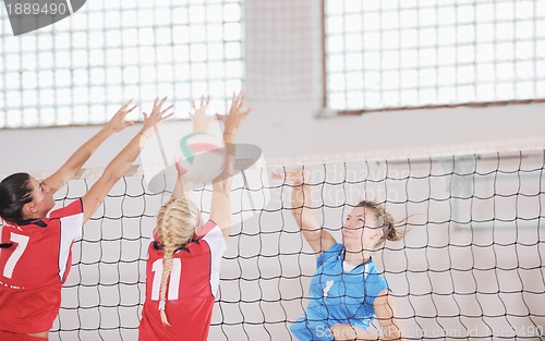 Image of girls playing volleyball indoor game