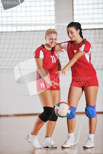 Image of girls playing volleyball indoor game
