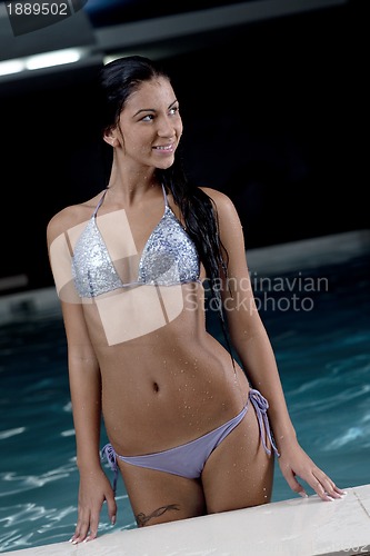 Image of pretty young lady  relaxing in the swimming pool