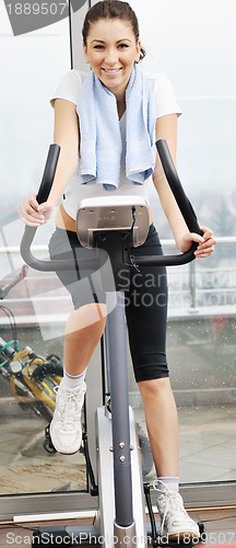 Image of womanworkout  in fitness club on running track machine 