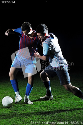 Image of football players in competition for the ball