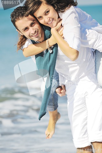 Image of happy young couple have fun at beautiful beach