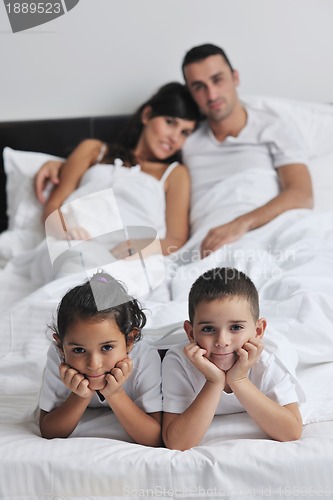 Image of happy young Family in their bedroom