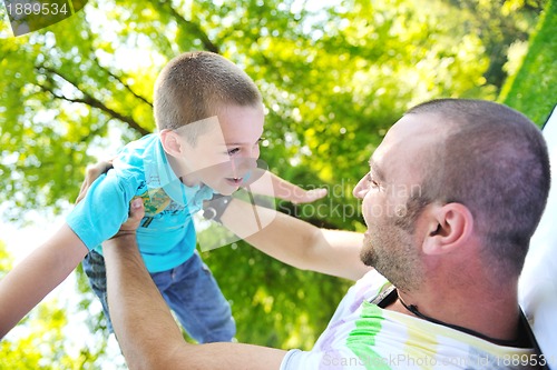 Image of happy father and son have fun at park