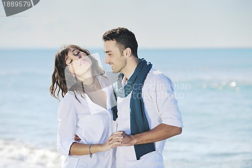 Image of happy young couple have fun at beautiful beach