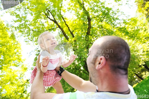 Image of man and baby playing in park