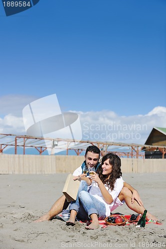 Image of young couple enjoying  picnic on the beach