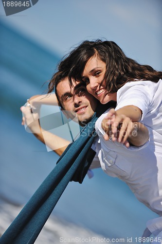Image of happy young couple have fun at beautiful beach