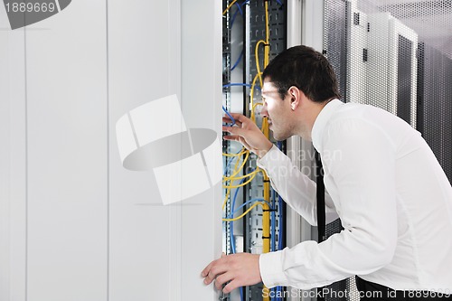 Image of young it engeneer in datacenter server room