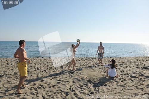 Image of young people group have fun and play beach volleyball