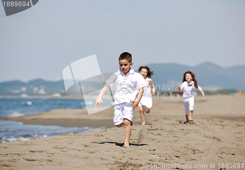 Image of happy child group playing  on beach