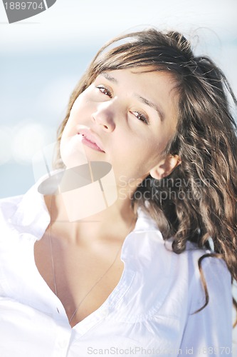 Image of happy young woman on beach