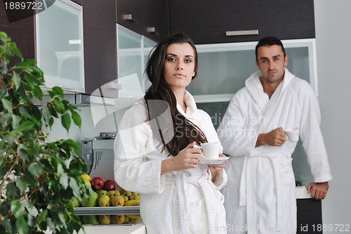 Image of Young love couple taking fresh morning cup of coffee