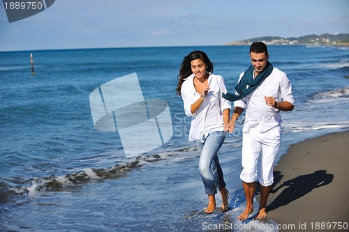 Image of happy young couple have fun at beautiful beach