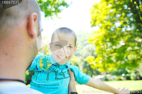 Image of happy father and son have fun at park