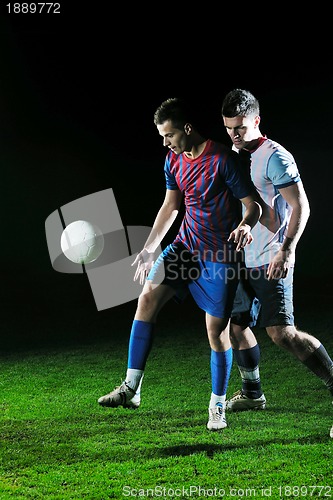 Image of football players in competition for the ball