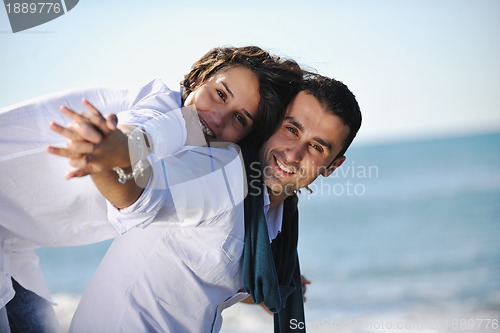 Image of happy young couple have fun at beautiful beach