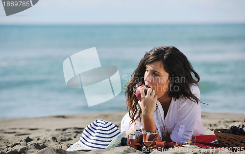 Image of happy young woman on beach