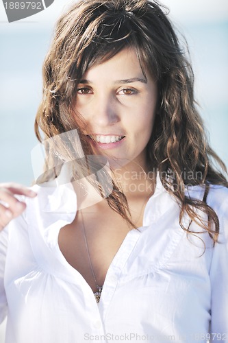 Image of happy young woman on beach