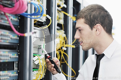 Image of young it engeneer in datacenter server room