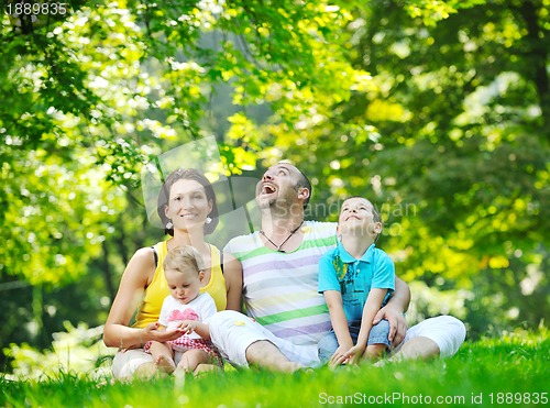 Image of happy young couple with their children have fun at park