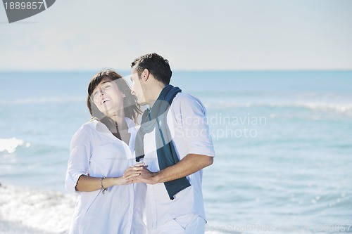 Image of happy young couple have fun at beautiful beach