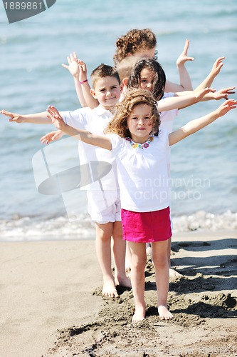 Image of happy child group playing  on beach