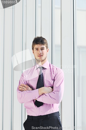 Image of young business man alone in conference room