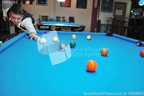 Image of young man play pro billiard game 