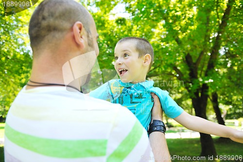 Image of happy father and son have fun at park