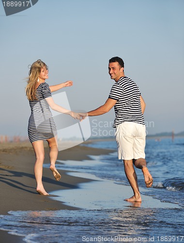 Image of happy young couple have romantic time on beach