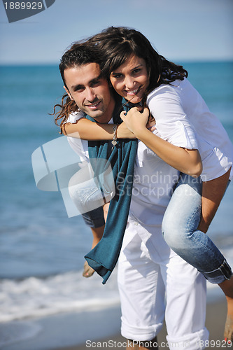Image of happy young couple have fun at beautiful beach