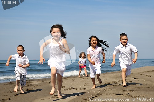 Image of happy child group playing  on beach