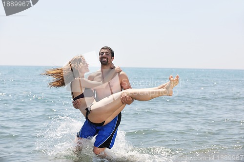Image of happy young couple have fun on beach