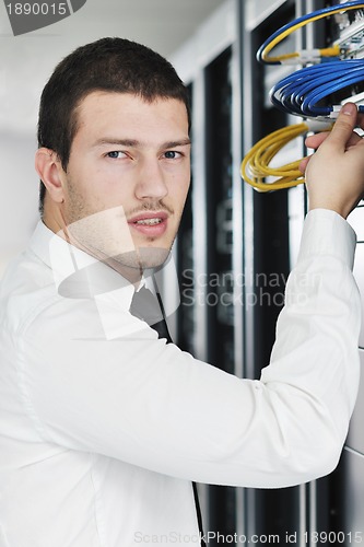 Image of young it engeneer in datacenter server room